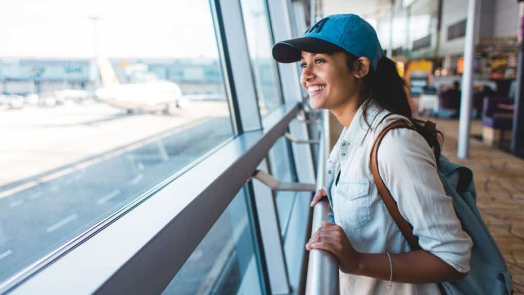 Young woman excited and waiting her trip at the airport
