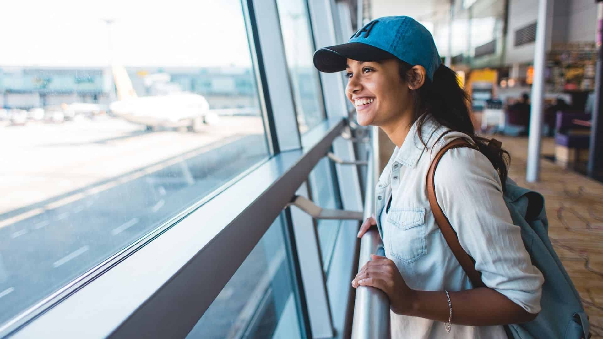 Young woman excited and waiting her trip at the airport