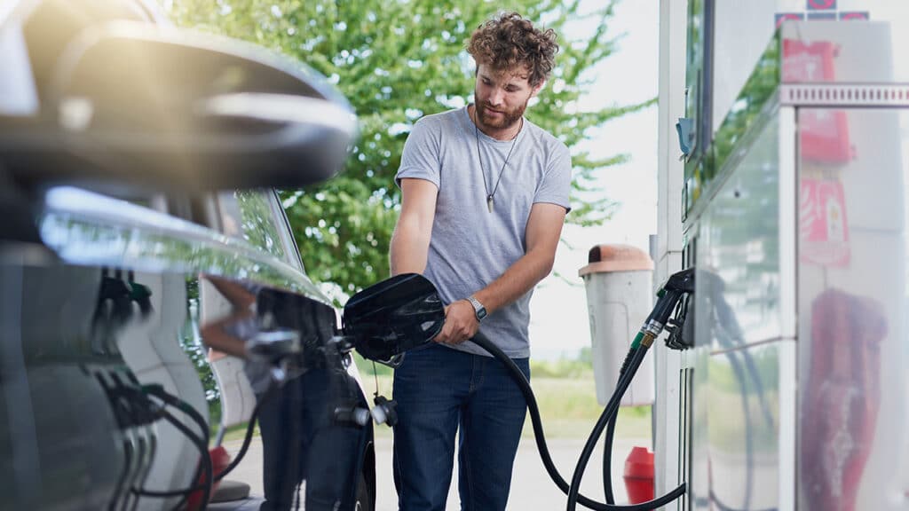 man using a gas pump