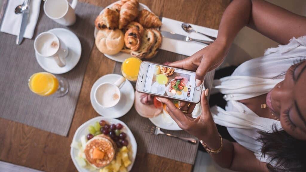 woman taking picture of her free hotel breakfast