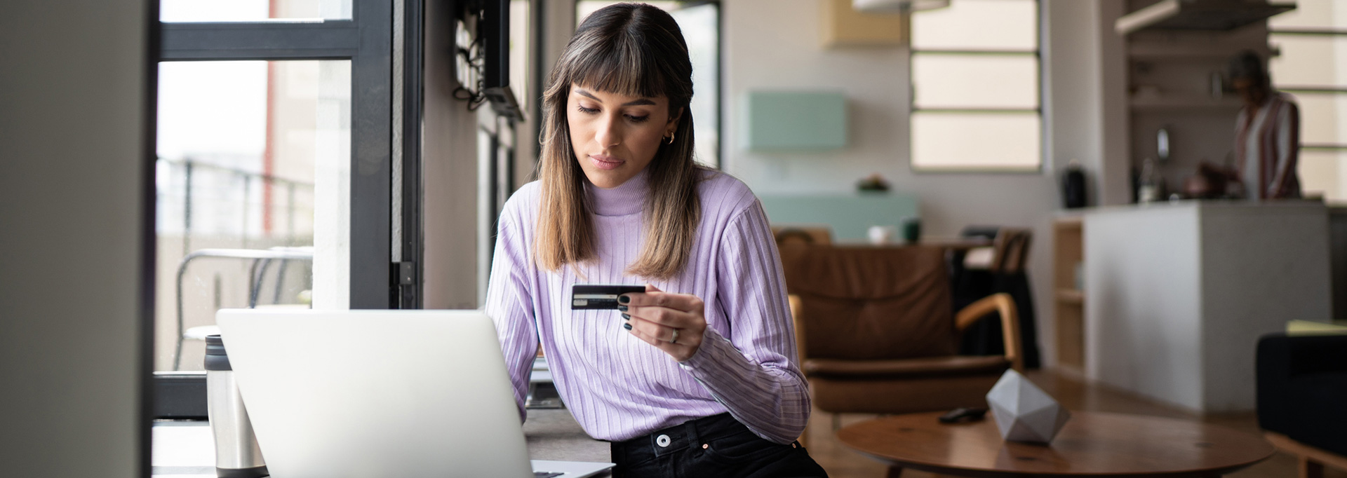 woman on computer with credit card