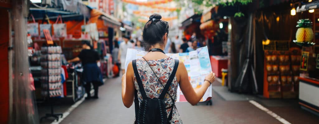 woman reading map traveling in singapore 