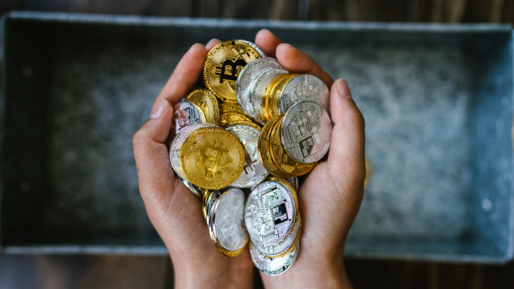 hands holding cryptocurrency coins