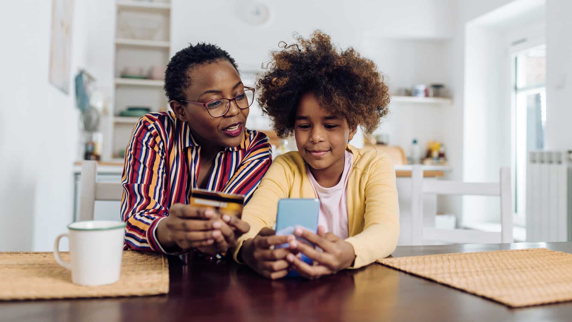 parent teaching child how to use credit card