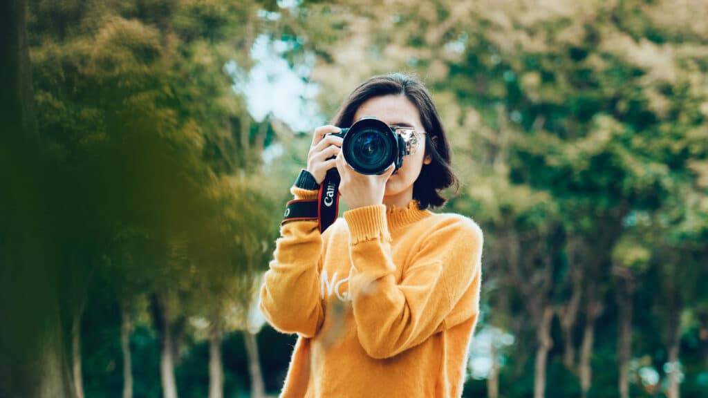 woman taking photographs with camera