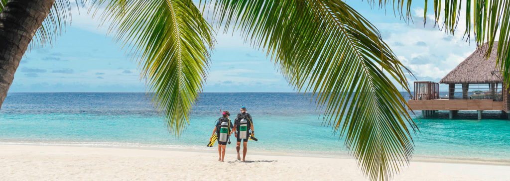 couple scuba diving at W Maldives