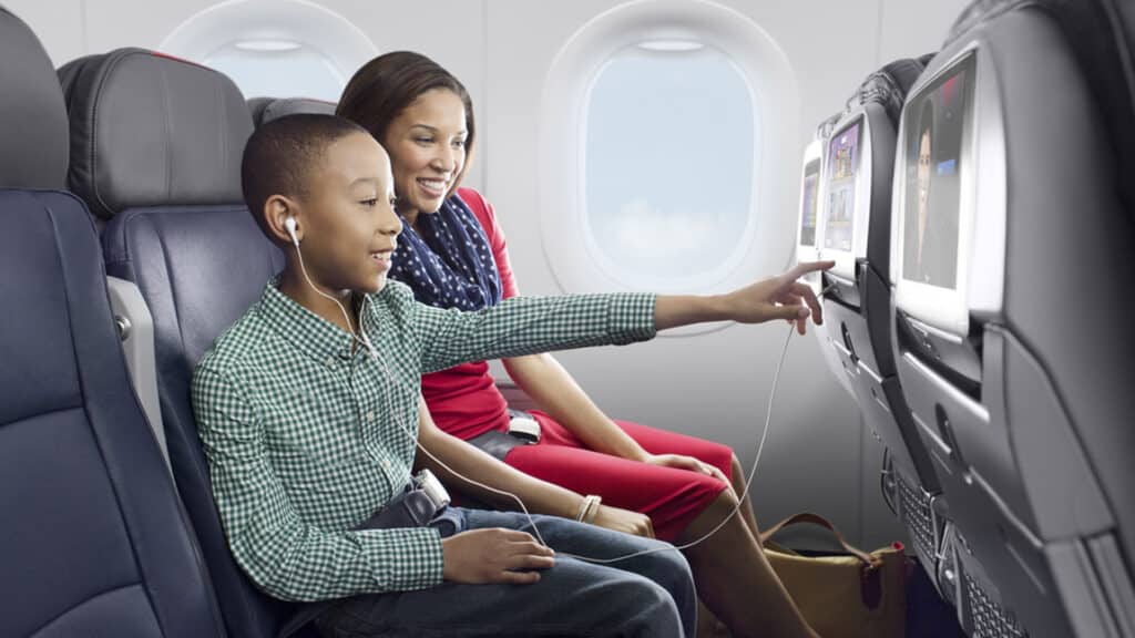 family traveling on American Airlines flight watching movies