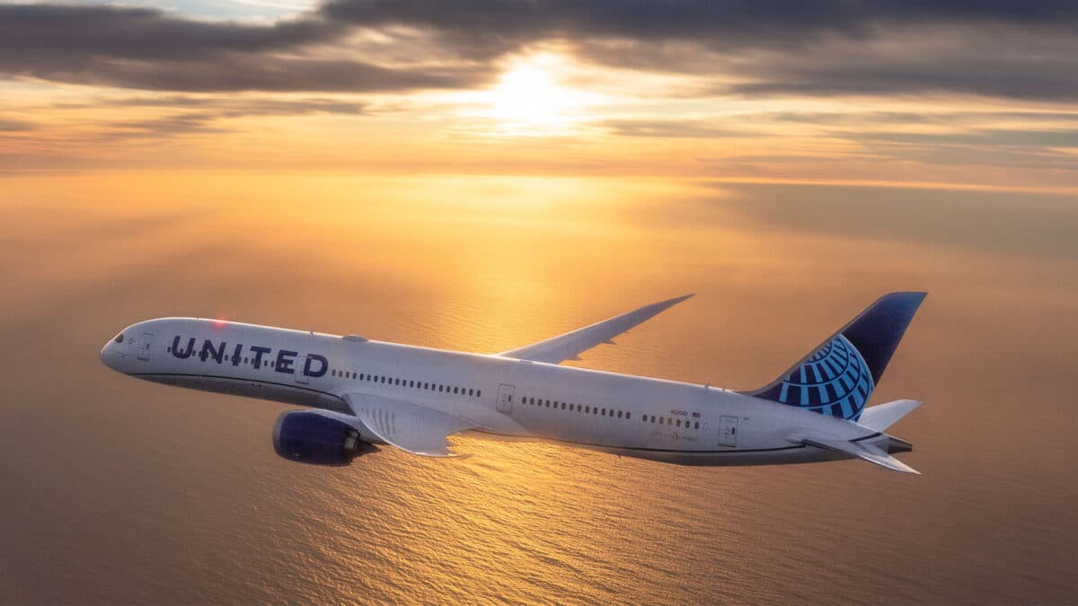 United plane flying at sunset