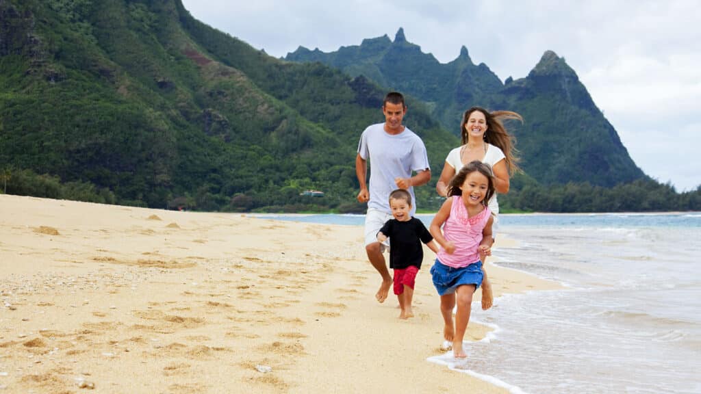 family running on the beach in Hawaii