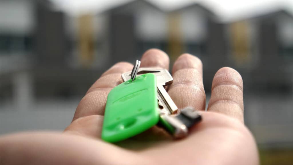 hand holding key to rental apartment