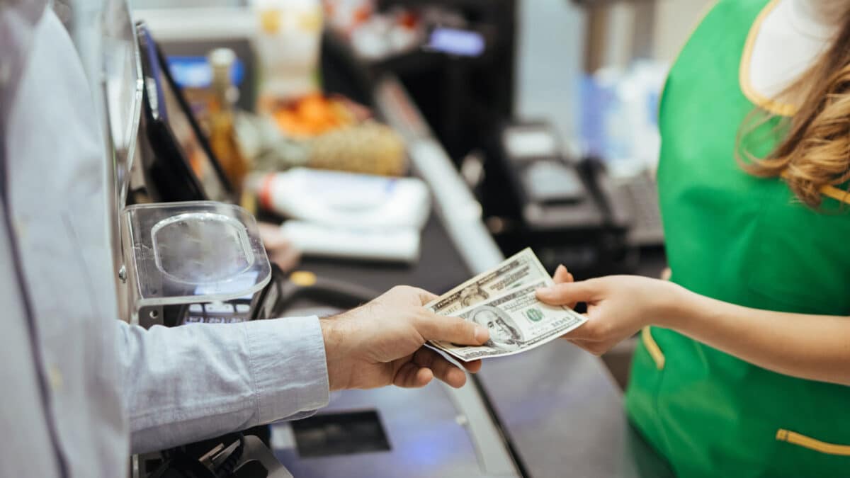 paying cash at grocery store