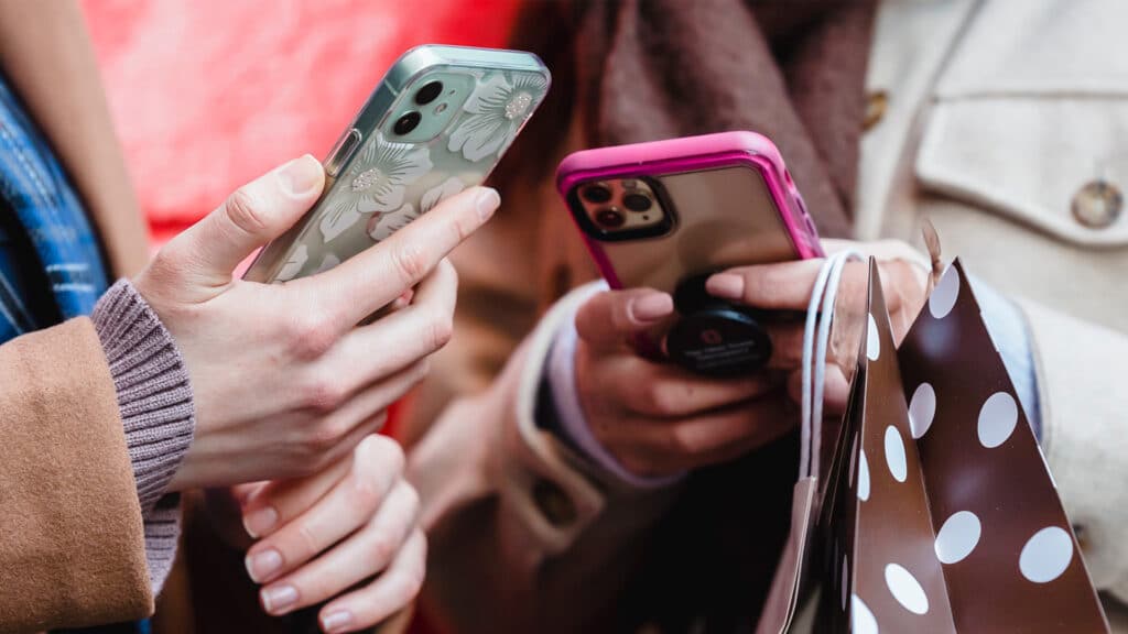 friends holding smartphones