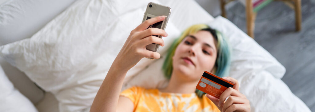 woman shopping with credit card on phone