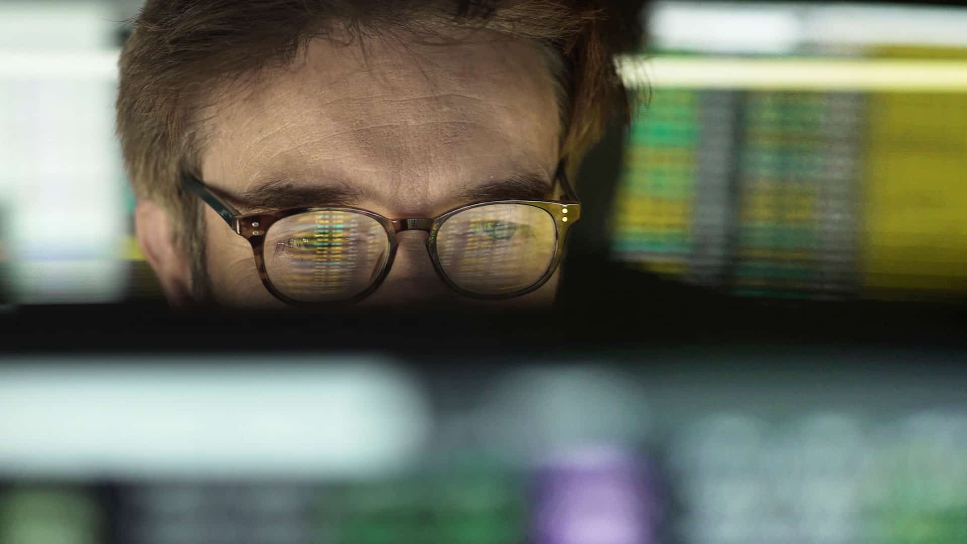 man monitoring stock prices on computer