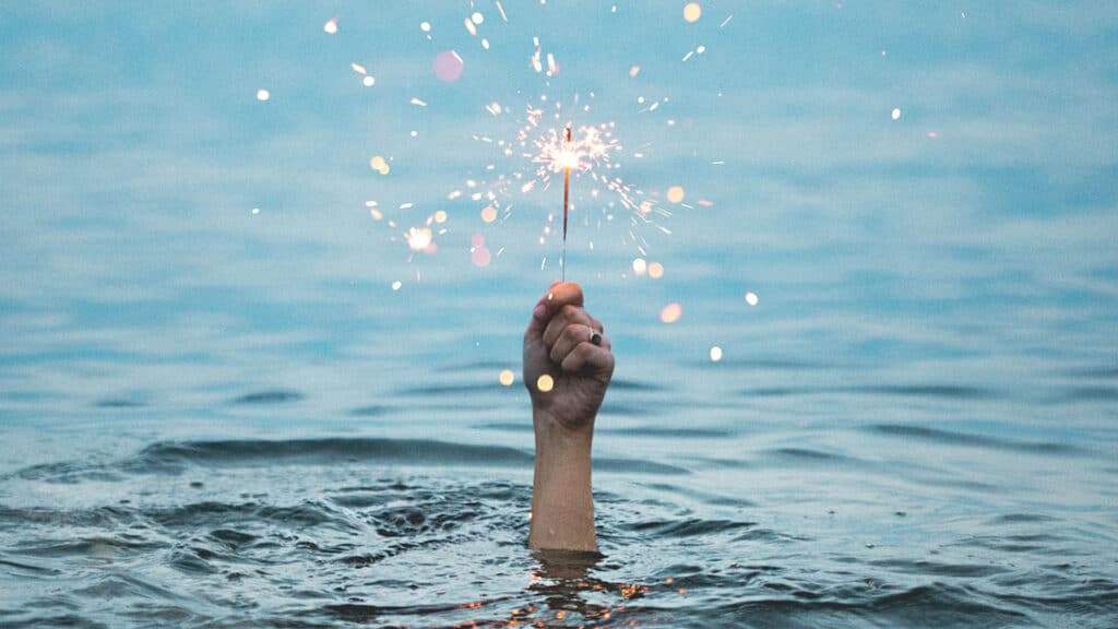 drowning hand holding sparkler