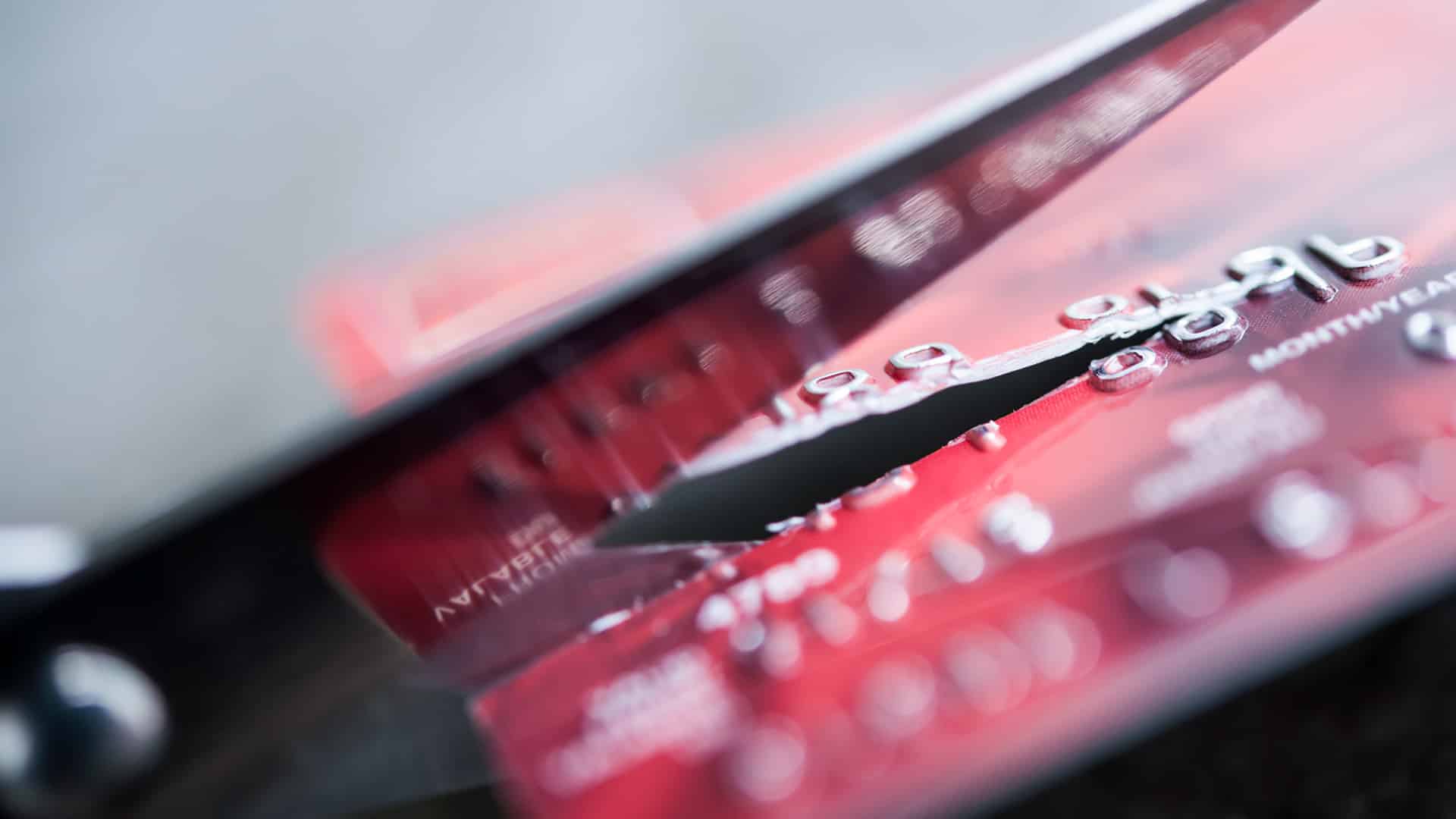 cutting credit card with scissors