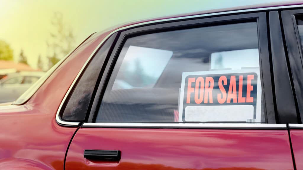 used car with for sale sign