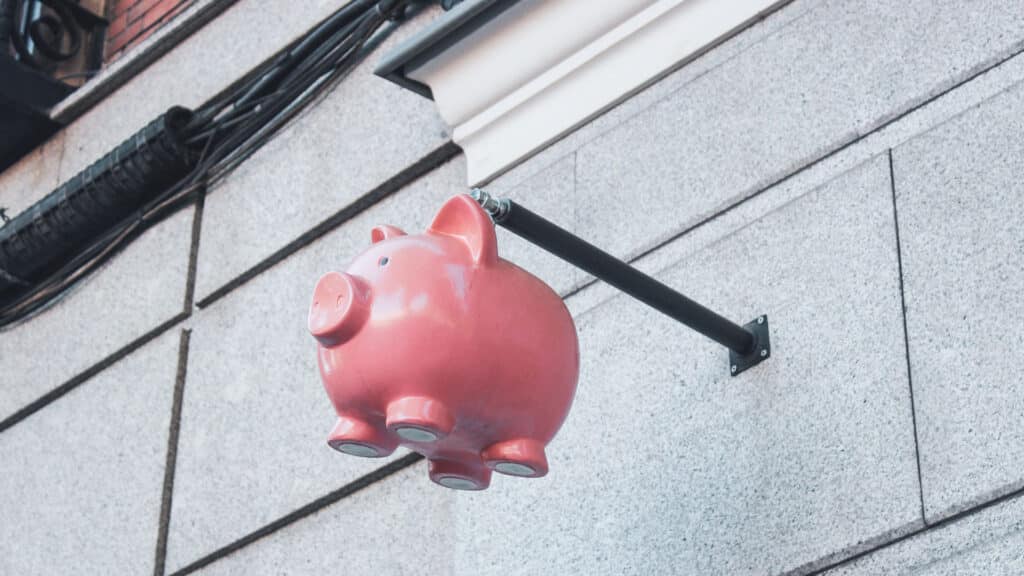piggy bank hanging sign on bank