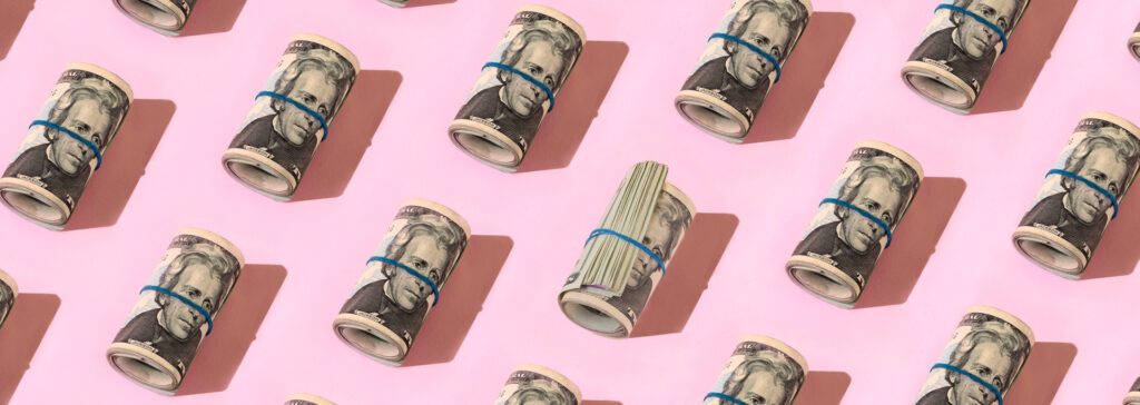 rolls of money on pick background