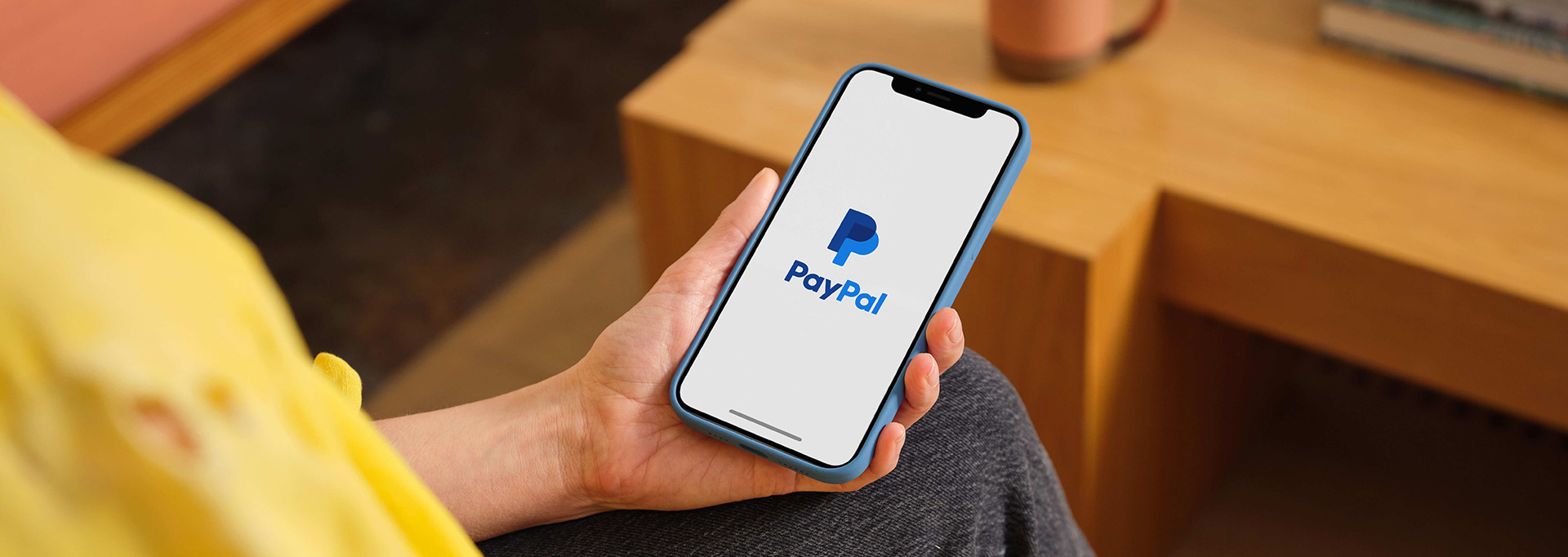 PayPal app on phone in hand