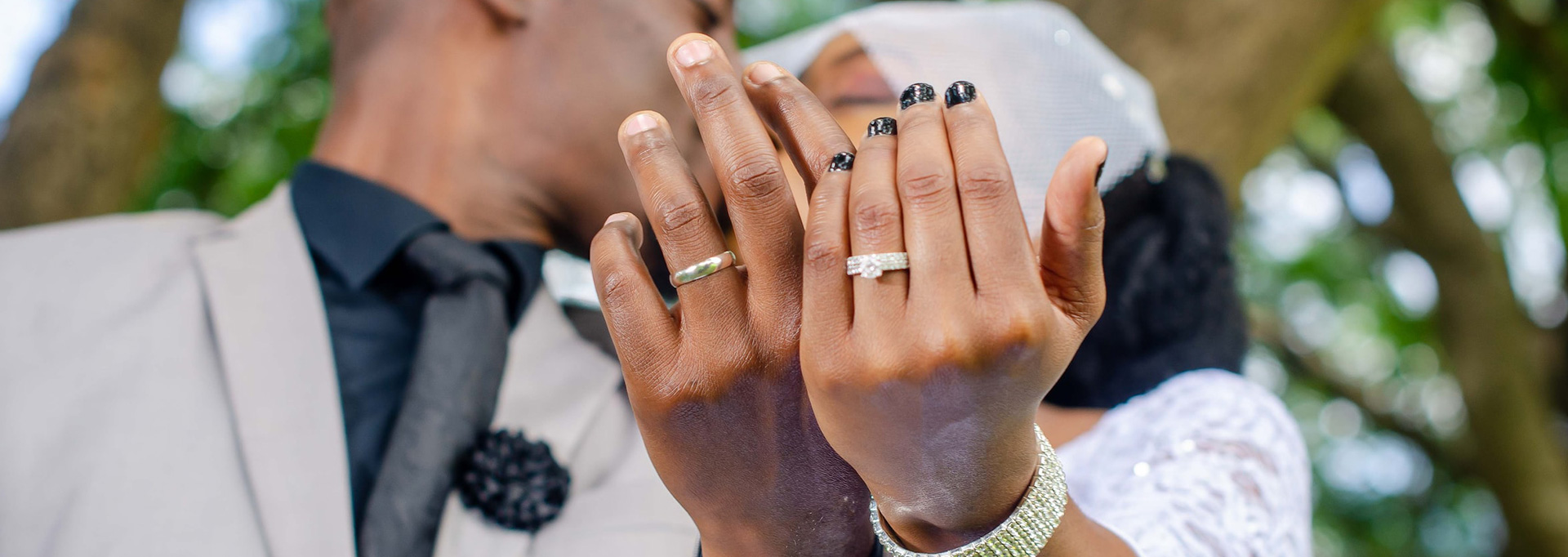 married couple's hands and rings