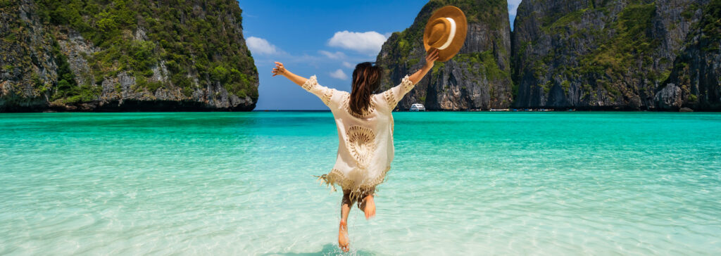 woman jumping into the water in thailand