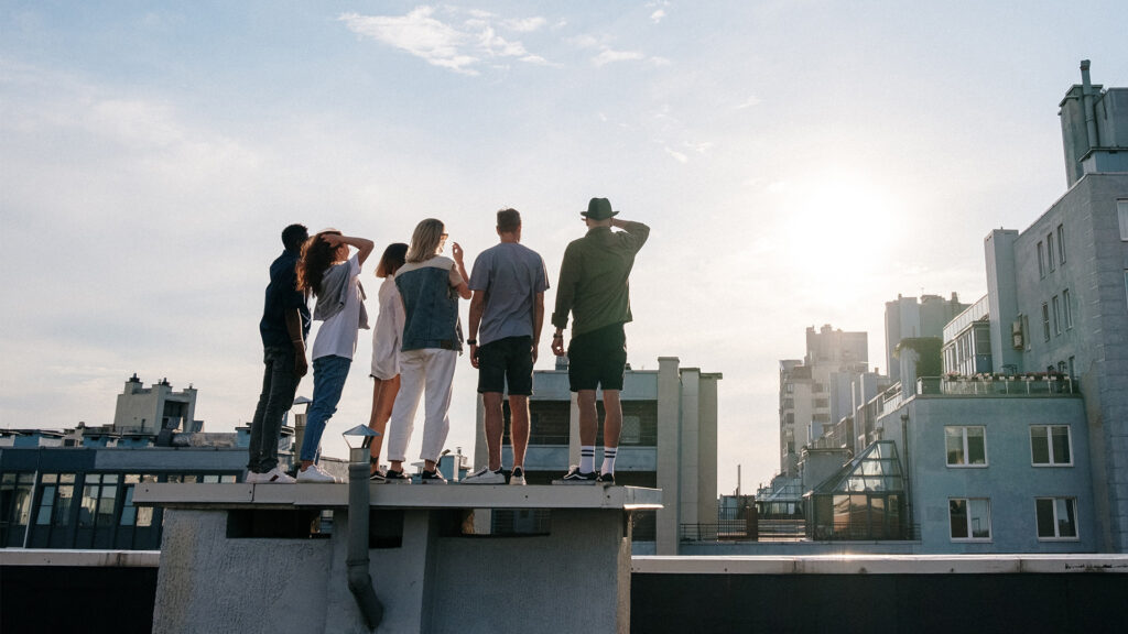 friends on rooftop in city