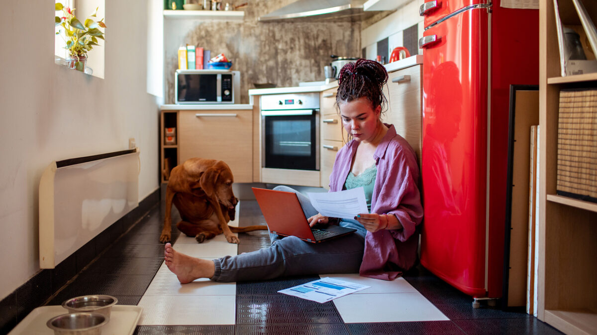 woman reviewing finances in kitchen