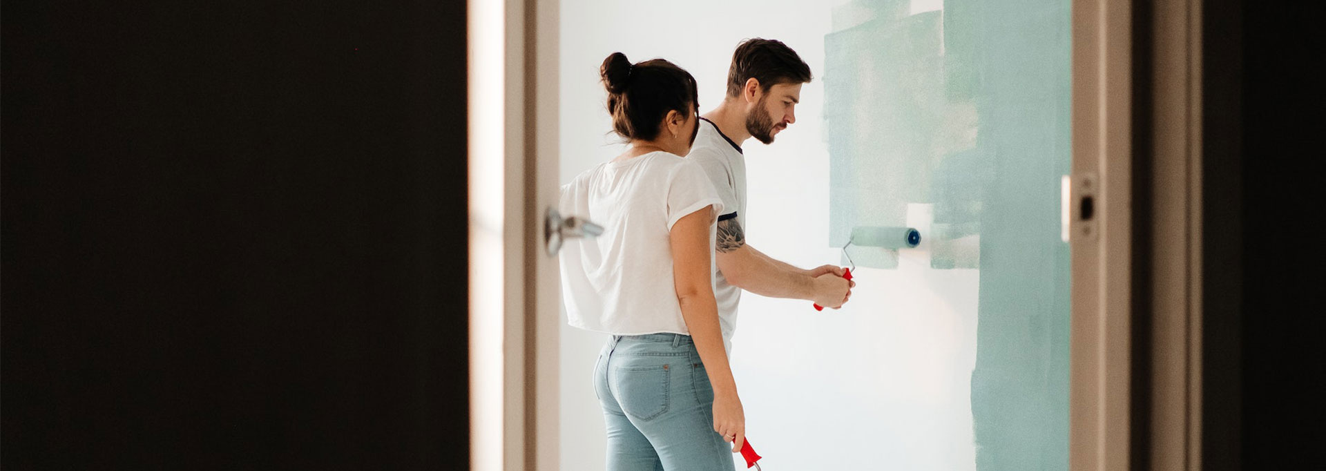 couple painting a room in their home