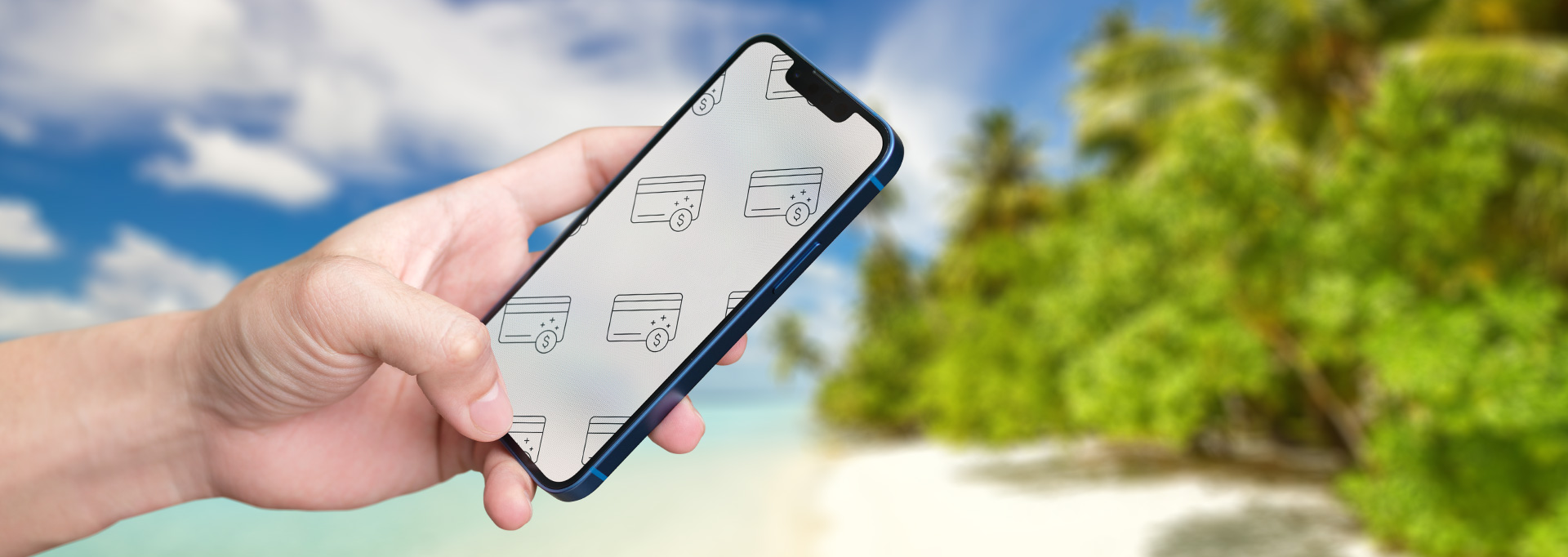 hand holding phone over exotic beach