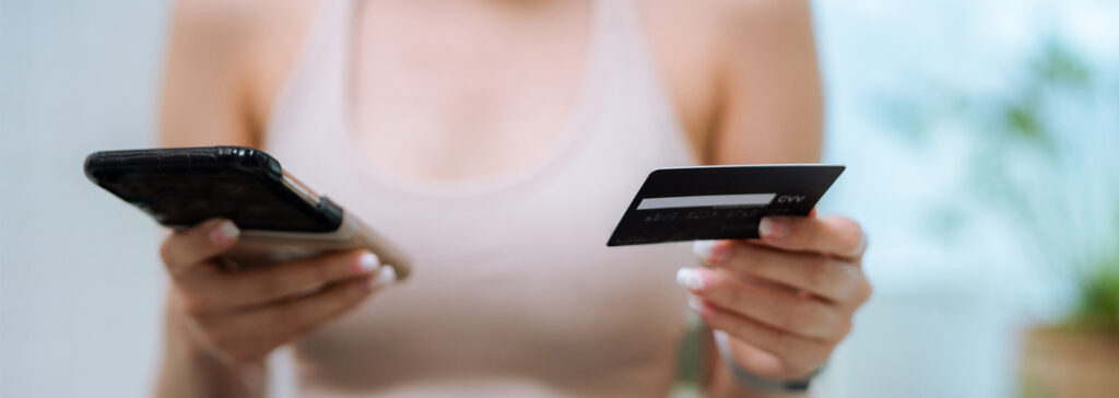 woman holding phone and credit card