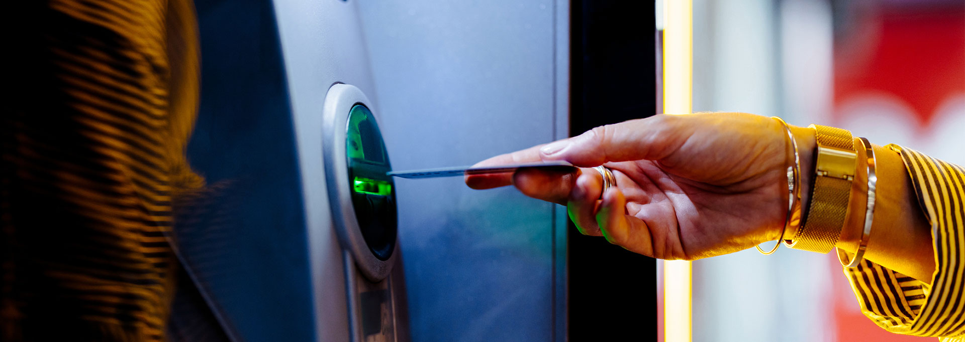 hand inserting card into atm