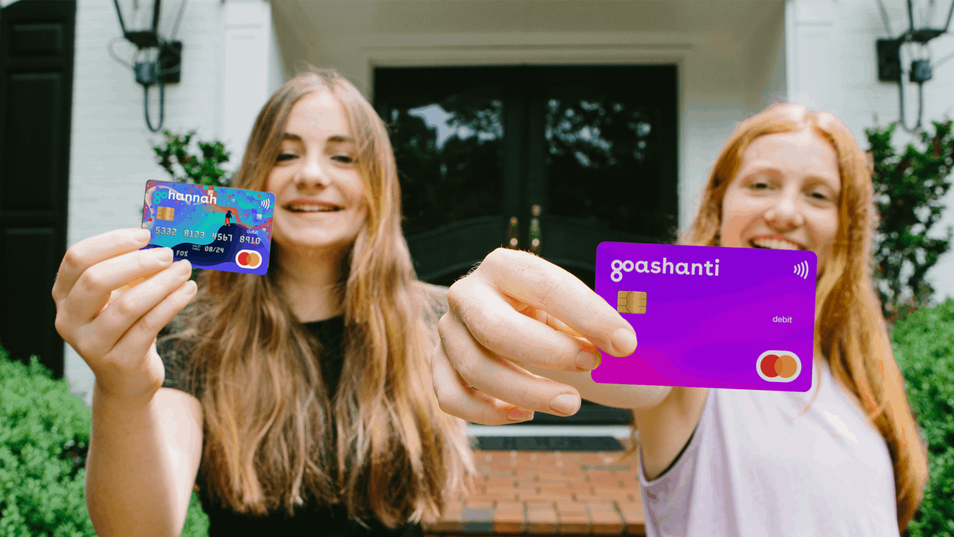 teen girls holding GoHenry cards