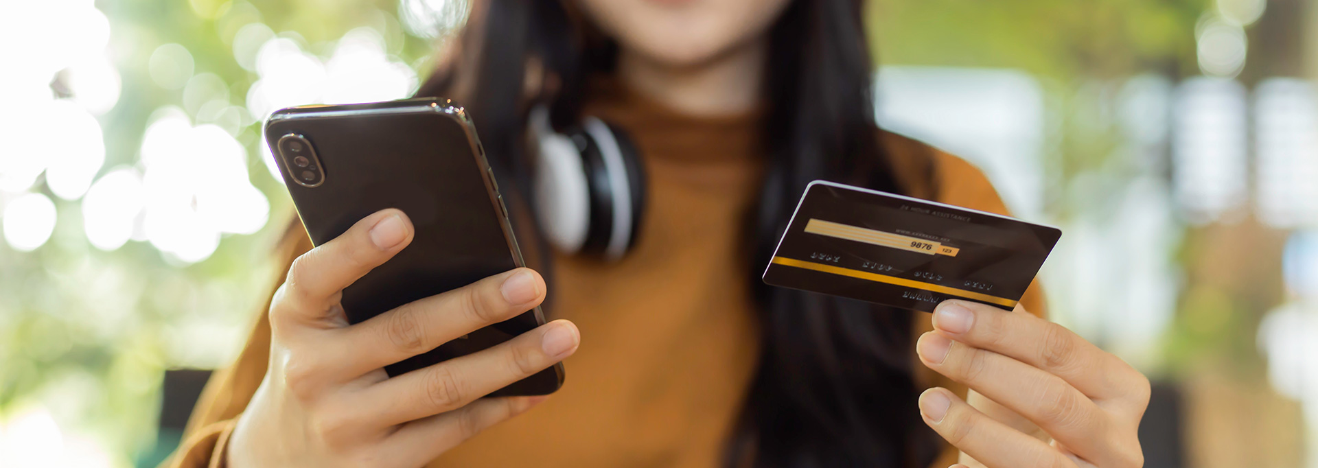 girl holding credit card and phone