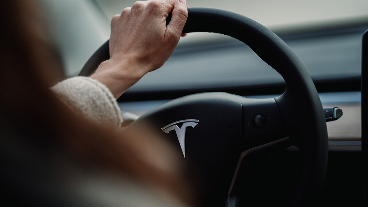 woman driving a Tesla