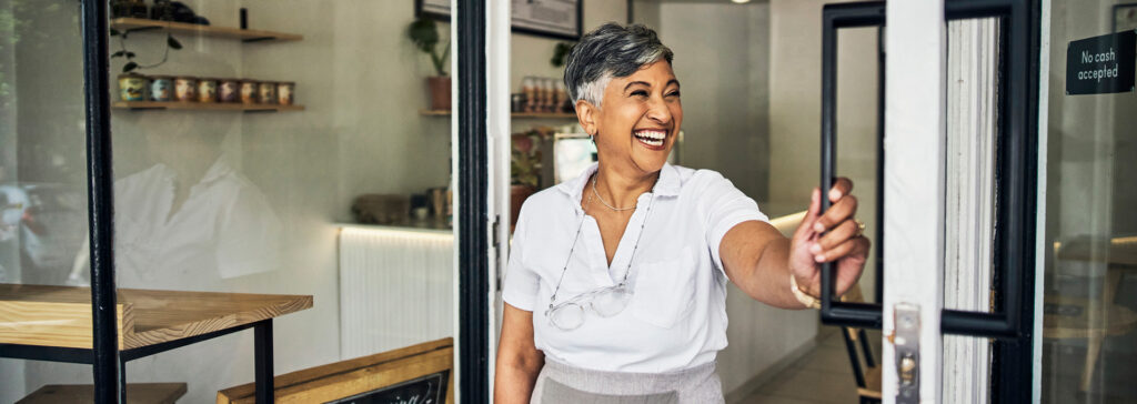 cafe business owner in store doorway