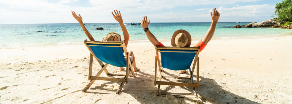 two people on a beach in chairs